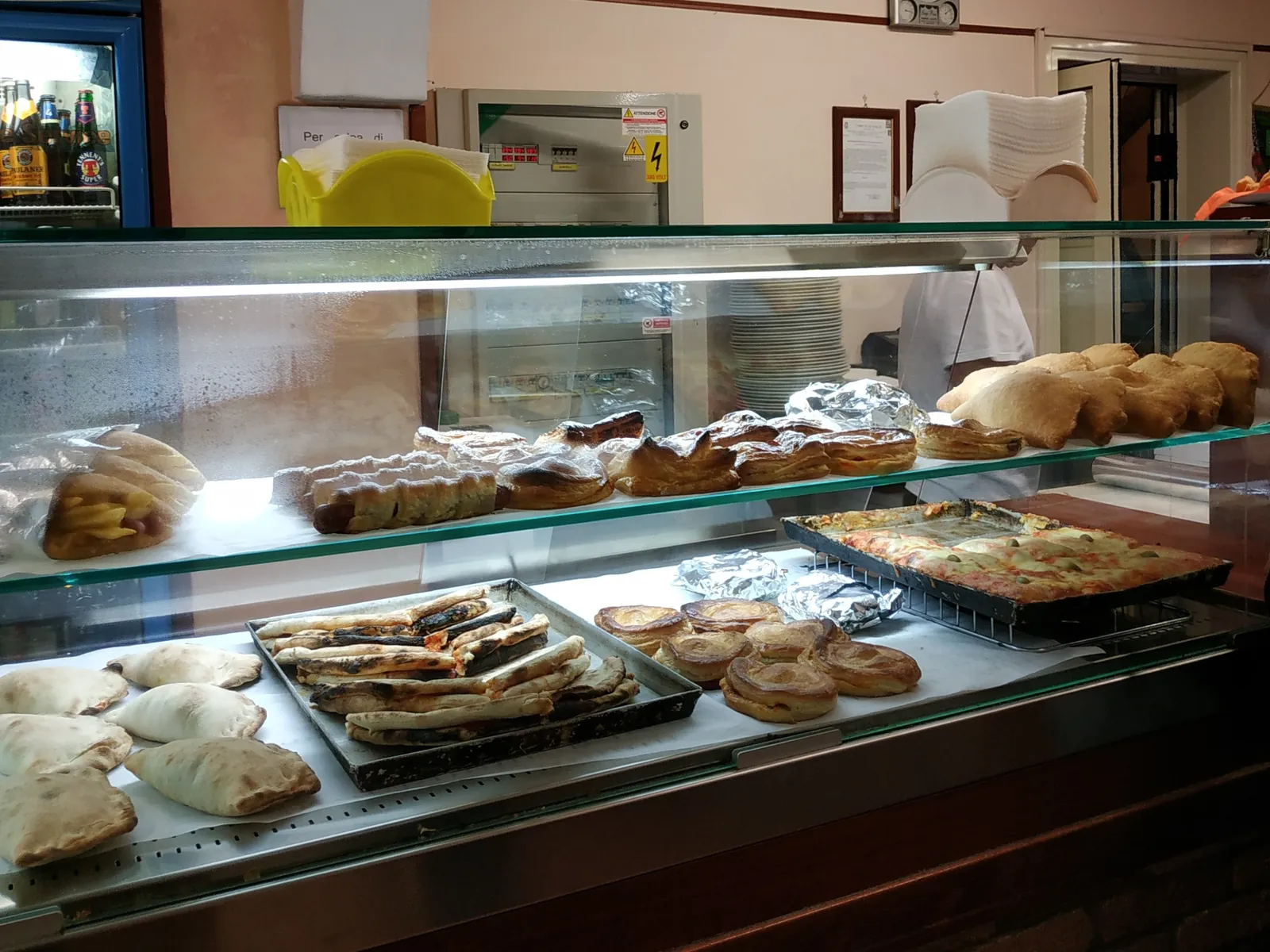 A rosticceria window in Salento with rustici, pizzette and calzoni