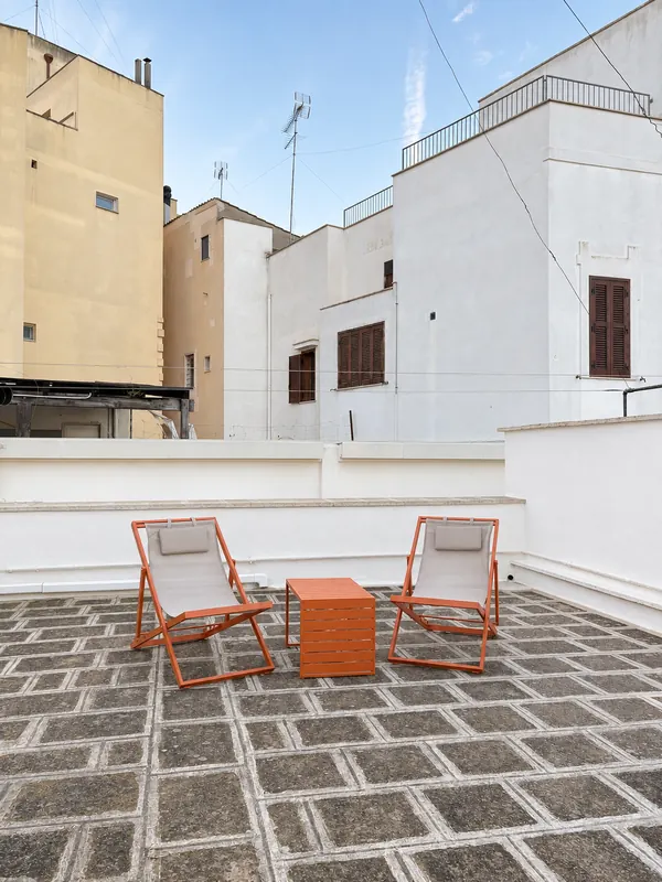 Private rooftop terrace with deck chairs over the roofs of Brindisi old town